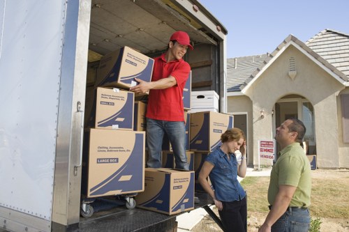 Loading household items into a van for a Chadwell Heath move
