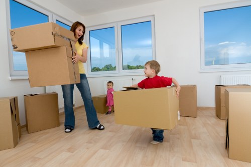 Packed moving boxes and furniture ready for transport in Chadwell Heath